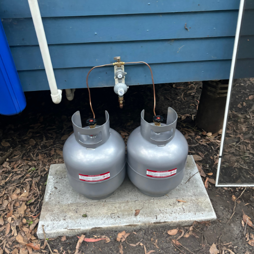 Two LPG cylinders installed beside a Couran Cove property